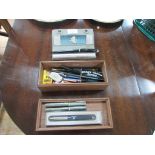 Box of pens and desk stand