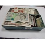 Tin of old coins and bank notes