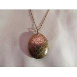 A 14ct gold (tested), locket on a chain. Gross weight: 9.4g