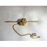 A 22ct gold bar brooch (tested), with gold nugget and a solitaire diamond. Gross weight: 10.2g