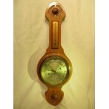 A wall barometer by O. Comitti & Son Ltd, London.