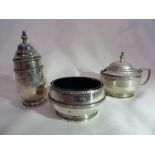 A 1919 silver Birmingham silver mustard pot with blue glass inner and matching pepper pot- by Walker