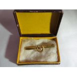 A 9ct gold horseshoe brooch. Clasp a/f. Boxed. 0.7g