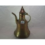 A Middle Eastern copper and brass tea pot.