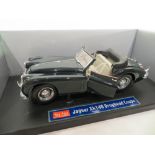 A Jaguar XK140 Drophead Coupe die cast metal model car by Sun Star. Scale 1:18.