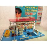 An Esso service station foldaway vintage toy, by Woolbro (Hong Kong).