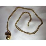 A 9ct gold muff chain with a spherical mourning locket and a heart pendant. Gross weight: 25.4g