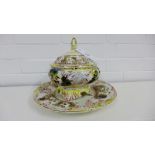 A Capodimonte tureen and stand with figures and scrolling leaf patterns, plate diameter 33cm