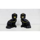 A pair of Staffordshire black glazed chimney spaniels each with gilded chains and collar (2), height