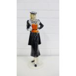 An A.W. Goebel Art Deco figure of a lady, the standing figure dressed in black skirt suit with