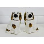 A pair of miniature white glazed and gilt chimney spaniels (2), 11cm high