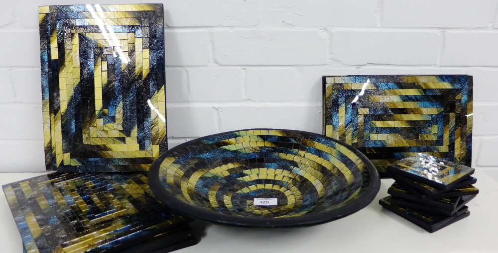 A contemporary mosaic glass serving set comprising fruit bowl, eight coasters and eight place