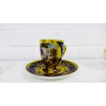 A Vienna porcelain cabinet cup and saucer painted with Classical figures against a cobalt and gilt