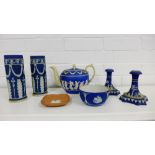 A collection of Wedgwood blue Jasperware to include a pair of candlesticks, a pair of vases, a small