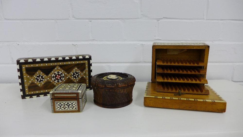 A collection of inlaid trinket boxes together with a musical cigarette box and a turned wood