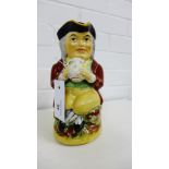 A Staffordshire Toby jug and cover, typically modelled as a gent seated in frock coat and tricorn