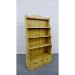 A pine waterfall bookcase with two short drawers to the base, 152cm x 85cm