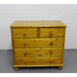 A pine chest with two short over three long drawers on bun supports, 76cm x 84cm