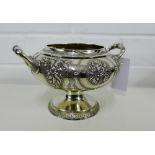 Victorian silver gilt twin handled bowl with floral repousee decoration, on a circular pedestal
