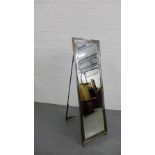 A contemporary metal framed cheval mirror with bevel plate on bun feet, 137cm high