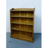 A pine open bookcase fitted four shelves on plinth base, 130cm x 11cm