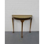 A mahogany demi lune side table with a pie crust rim on shell carved cabriole supports