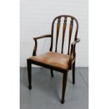 A 19th century mahogany open armchair with a carved splat back and upholstered slip in seat on