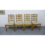 A set of four Ercol ladder back dining chairs with upholstered seat pads (4)