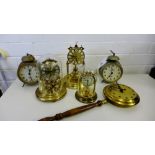 A collection of vintage clocks to include two tin cased alarm clocks, a clock in the form of a bed