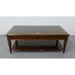 A contemporary mahogany coffee table, the rectangular top with frieze drawers on turned supports