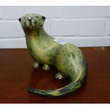 A carved wooden model of an otter, 22cm long