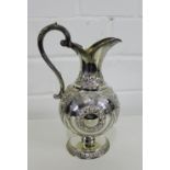 Victorian silver jug with repousee floral sprays, on a circular footrim with makers mark for William