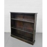 A stained pine open bookcase the rectangular top over three adjustable shelves on a plinth base,