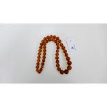 A strand of graduated amber beads, approx 70cm, largest bead has a diameter of 19mm, with an overall