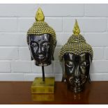 A silver lustre and gilded Buddha head on plinth base together with another (2), tallest 37cm