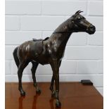 A leather model of a horse, modelled standing, 28cm high