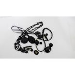 A collection of black jet and other beaded jewellery to include brooches, beads, buttons and
