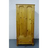 A pine two door wardrobe with a single long drawer to the base, 188cm x 84cm