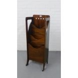 A Finnegans Art Nouveau mahogany magazine stand with pierced back and three tiers, on shape