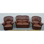 A leather three piece lounge suite comprising two-seater sofa and two easy chairs