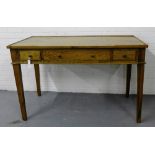 A contemporary oak side table, the rectangular top over one long and two short drawers with brass