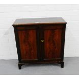 A mahogany cabinet, the rectangular top over two panel cupboard doors on bracket supports, 67cm x