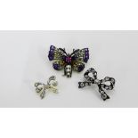 A paste set butterfly brooch, together with two paste set bow brooches (3)