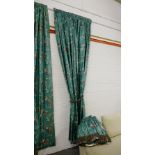 A pair of lined full length green butterfly and floral patterned curtains complete with tie backs