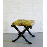 A black painted and gilt x-framed stool with a tapestry top, 42 x 42cm