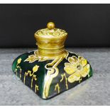 An Art Nouveau green glass and brass topped inkwell gilded with floral decoration, 8.5cm wide