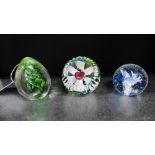 A collection of three paperweights to include a Selkirk glass limited edition paperweight, a