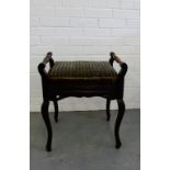 A piano stool with an upholstered lift-up top on cabriole supports, 60 x 50cm