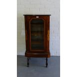 A rosewood and inlaid side cabinet, the rectangular top over a glazed door enclosing a shelved