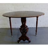 A mahogany drop flap side table, the oval top on fret work supports terminating in ceramic